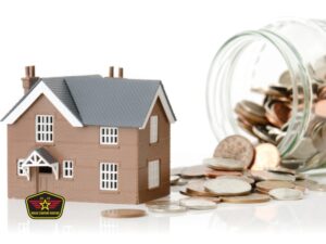 Bravo Company Roofing A model house sits next to a glass jar spilling coins, symbolizing home investment or savings; a badge with a house and stars is in the lower left corner.